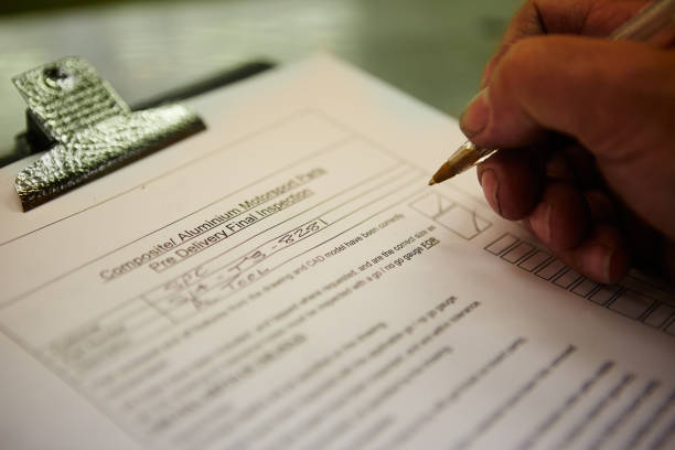 Close-up of a hand of an engineer filling a pre delivery inspection form